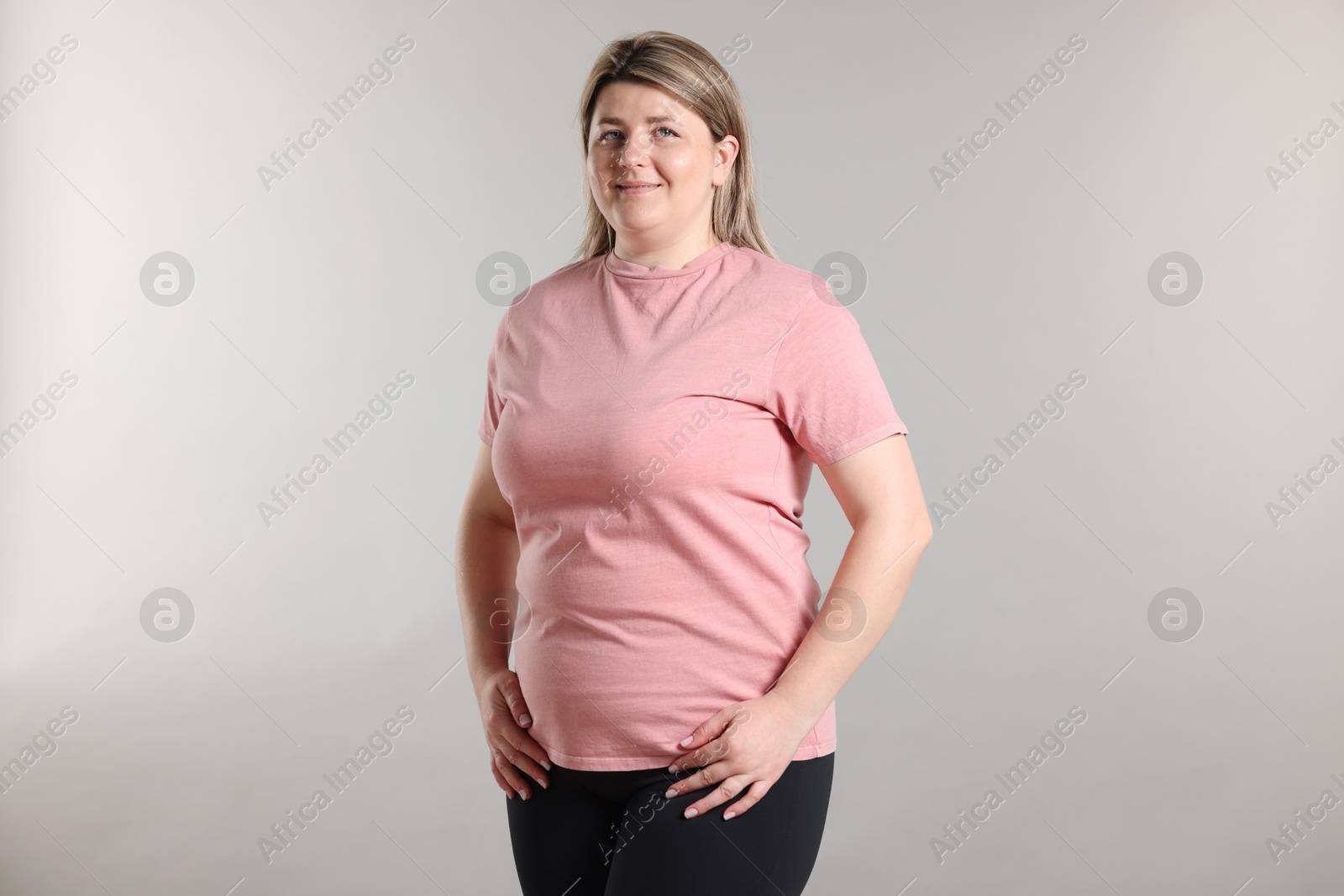 Weight loss. Plus size woman on gray background Photo of Weight loss. Plus size woman on gray background