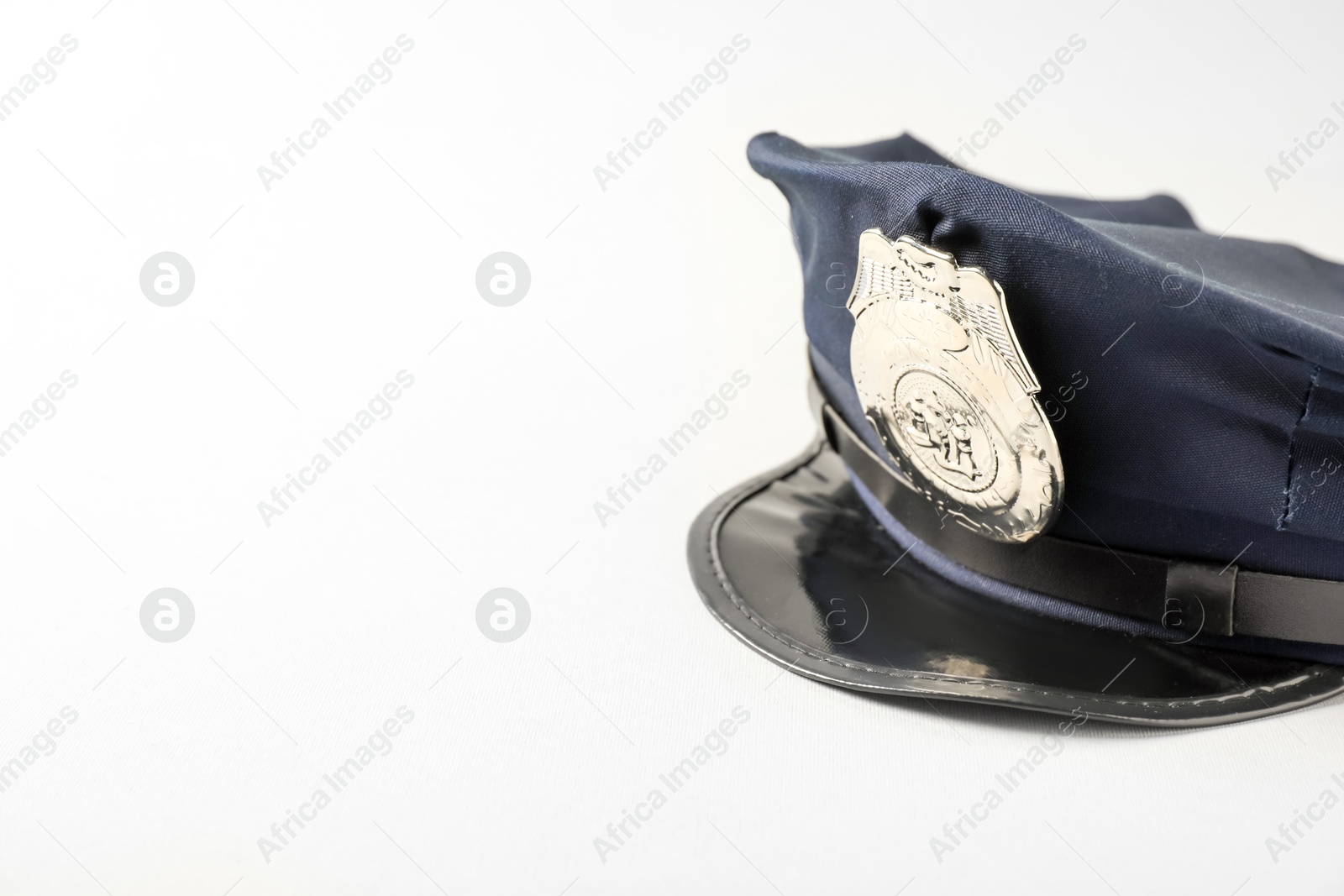One police cap on white background, closeup. Space for text Photo of One police cap on white background, closeup. Space for text