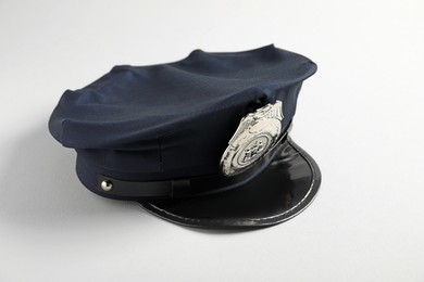 Photo of One police cap on white background, closeup