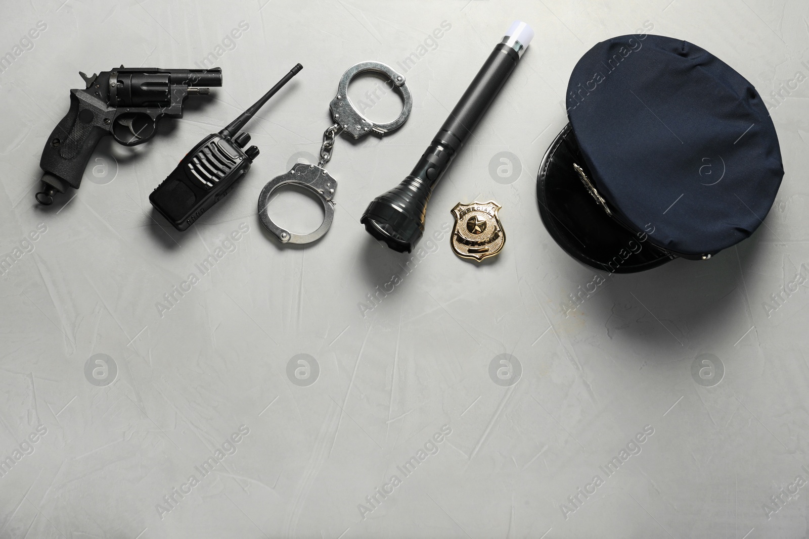 Photo of Different police equipment on light grey table, flat lay. Space for text