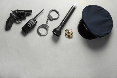 Photo of Different police equipment on light grey table, flat lay. Space for text