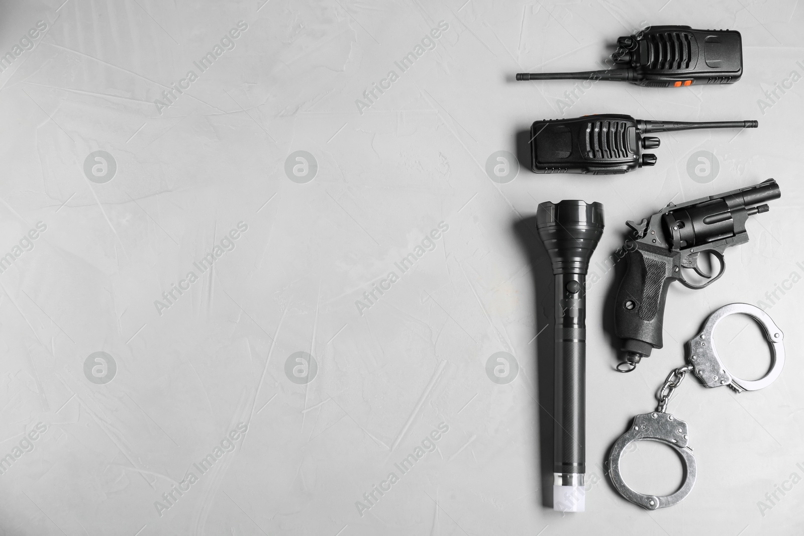 Photo of Different police equipment on light grey table, flat lay. Space for text