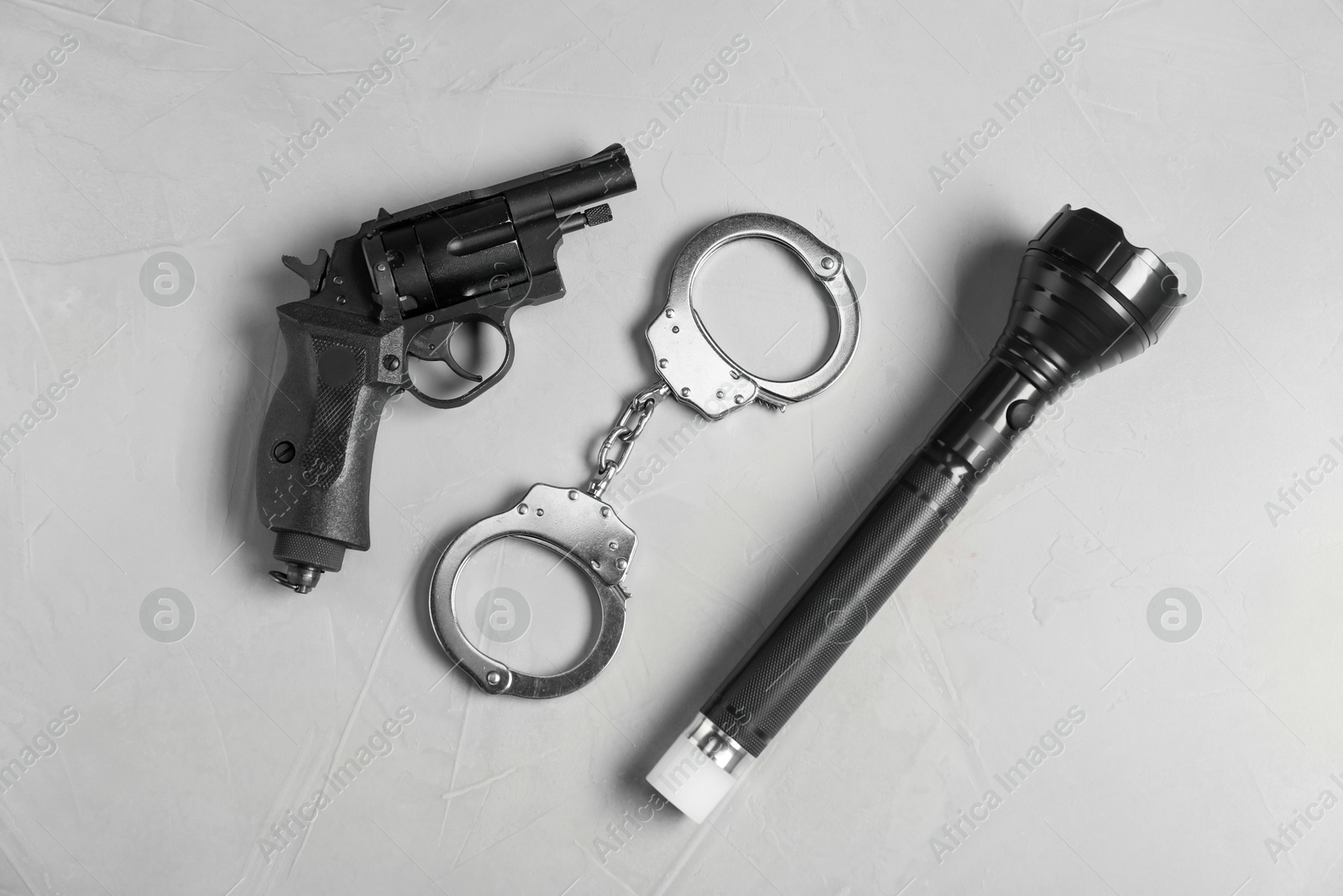 Different police equipment on light grey table, flat lay Photo of Different police equipment on light grey table, flat lay