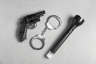 Photo of Different police equipment on light grey table, flat lay