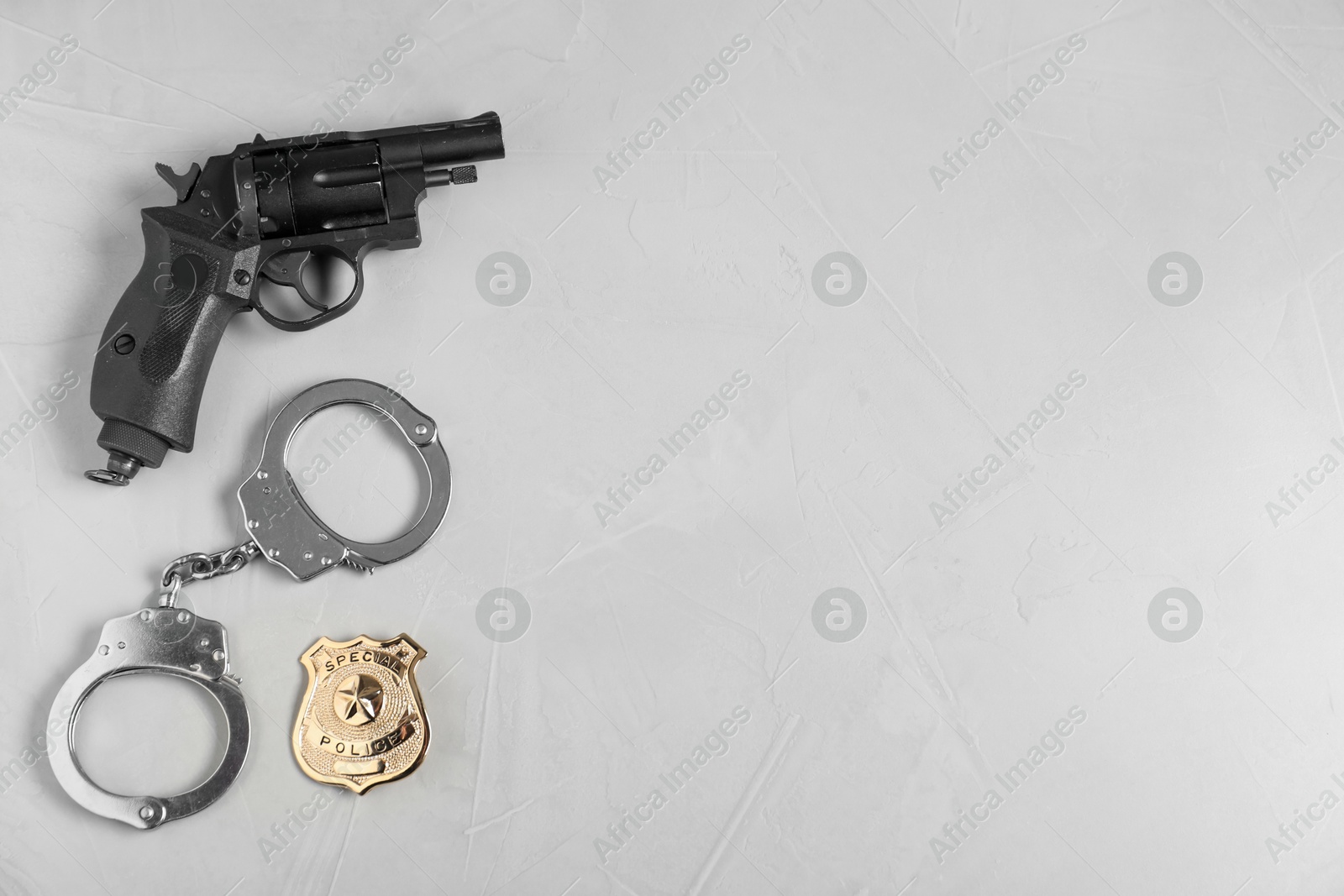 Different police equipment on light grey table, flat lay. Space for text Photo of Different police equipment on light grey table, flat lay. Space for text
