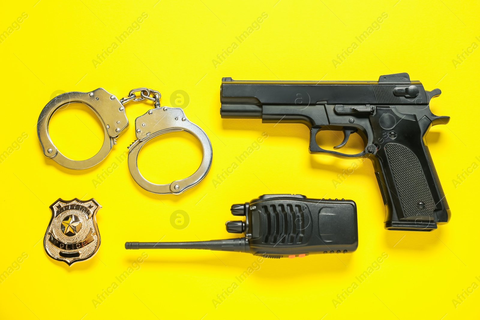Different police equipment on yellow background, flat lay Photo of Different police equipment on yellow background, flat lay