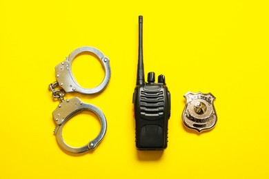Photo of Different police equipment on yellow background, flat lay