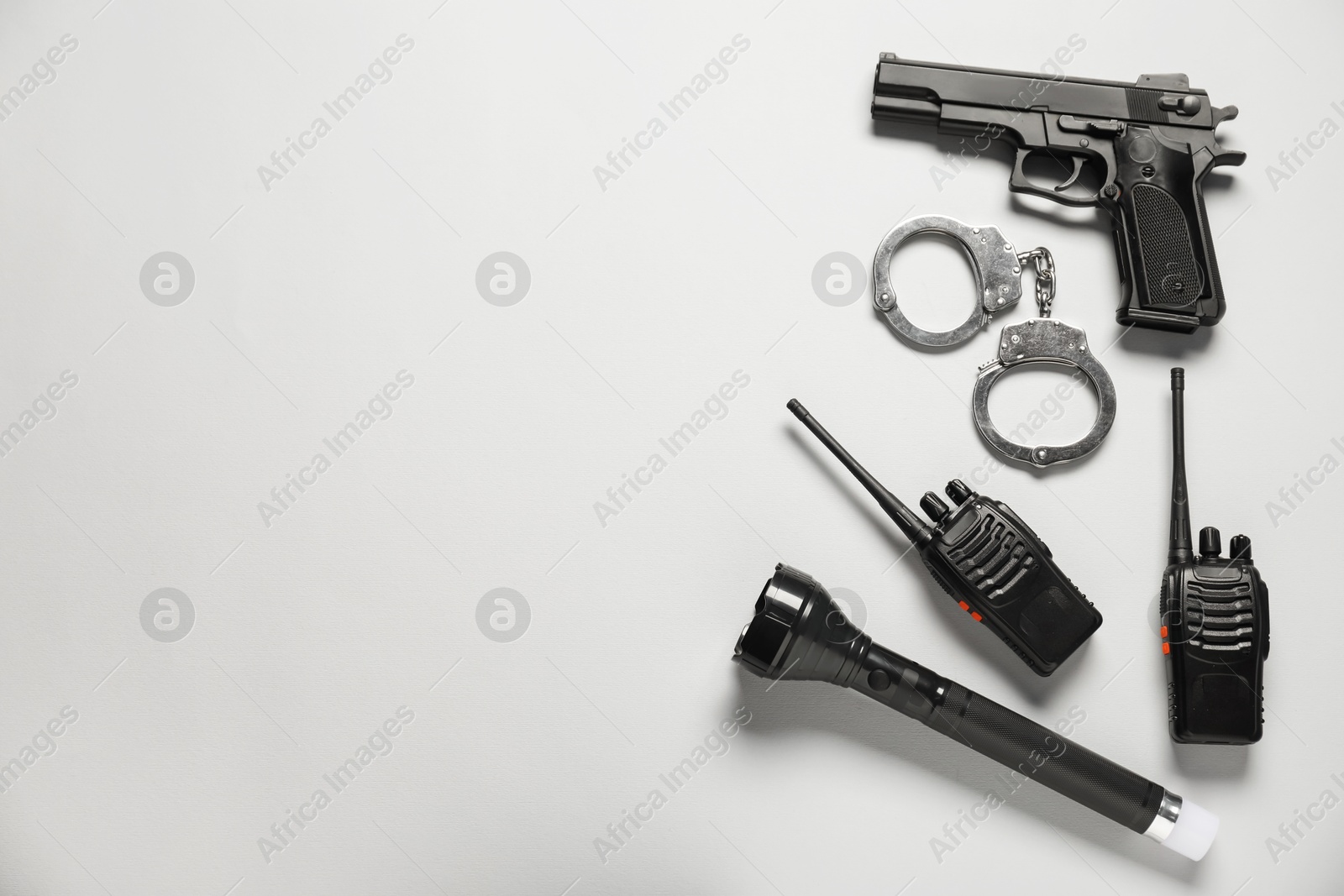Different police equipment on white background, flat lay. Space for text Photo of Different police equipment on white background, flat lay. Space for text