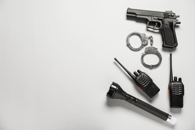Photo of Different police equipment on white background, flat lay. Space for text