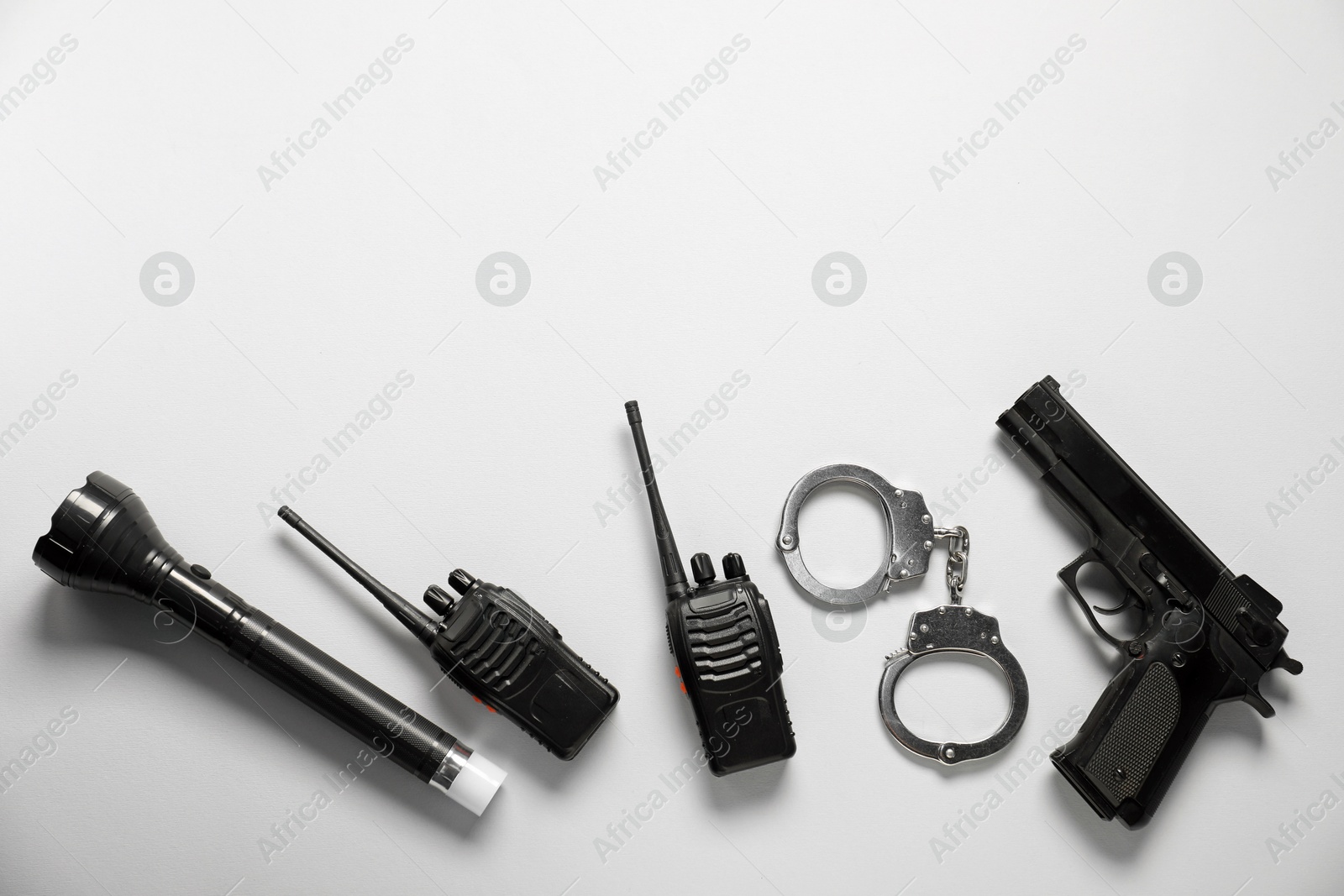 Different police equipment on white background, flat lay. Space for text Photo of Different police equipment on white background, flat lay. Space for text