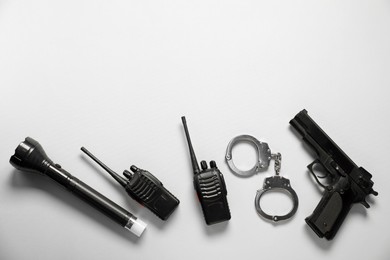 Photo of Different police equipment on white background, flat lay. Space for text
