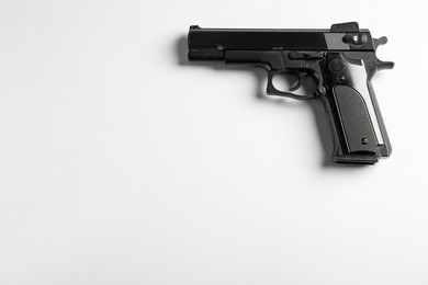 Photo of Police equipment. One black gun on white background, top view. Space for text