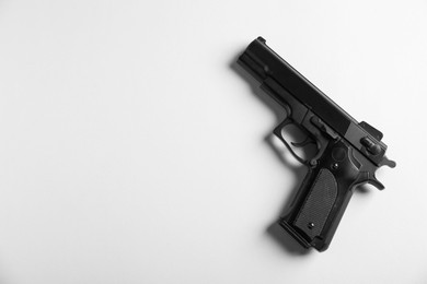 Photo of Police equipment. One black gun on white background, top view. Space for text