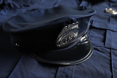 Photo of Police cap on dark blue uniform, closeup