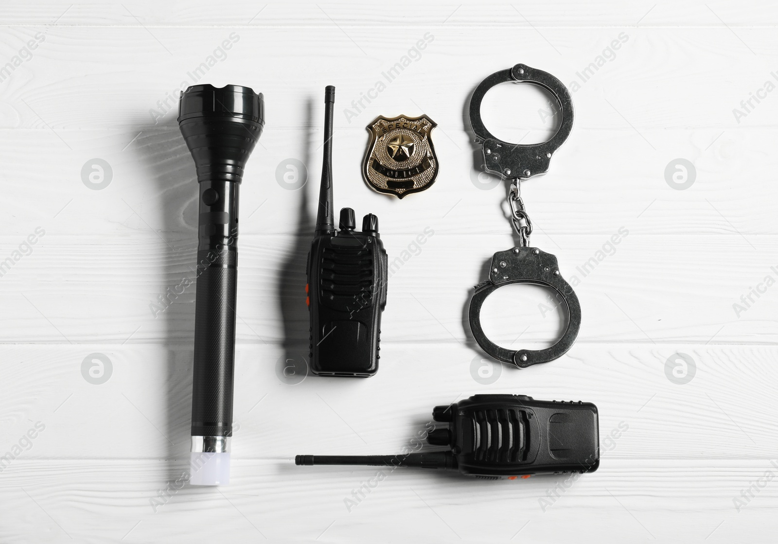Different police equipment on white wooden table, flat lay Photo of Different police equipment on white wooden table, flat lay