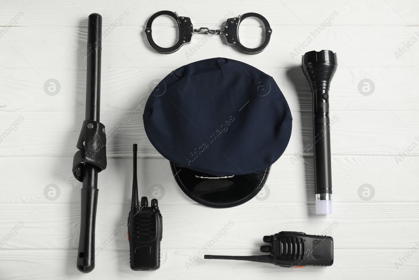 Different police equipment on white wooden table, flat lay Photo of Different police equipment on white wooden table, flat lay