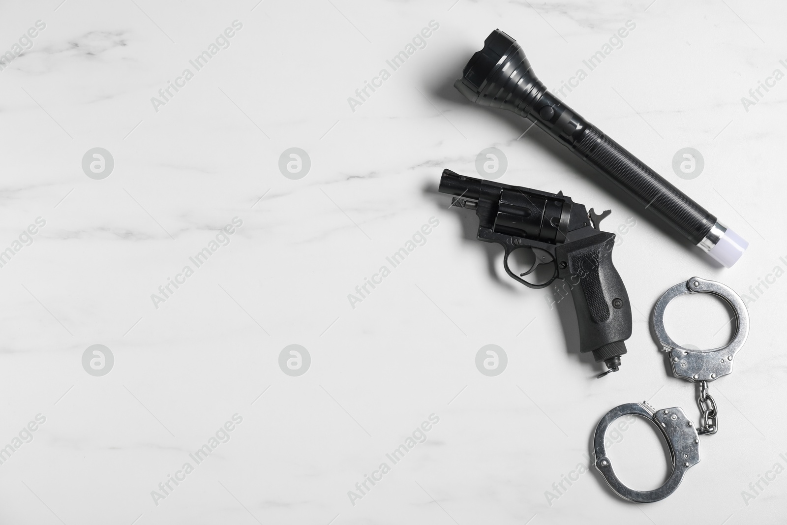 Different police equipment on white marble table, flat lay. Space for text Photo of Different police equipment on white marble table, flat lay. Space for text