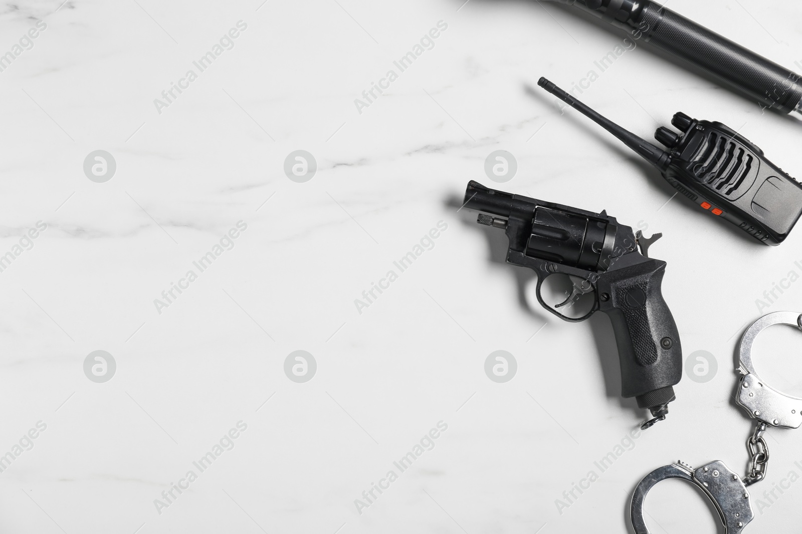 Different police equipment on white marble table, flat lay. Space for text Photo of Different police equipment on white marble table, flat lay. Space for text