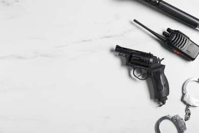 Photo of Different police equipment on white marble table, flat lay. Space for text