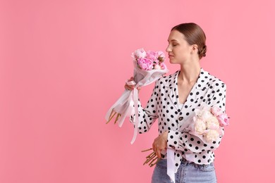 Photo of Woman with beautiful bouquets of peonies on pink background, space for text