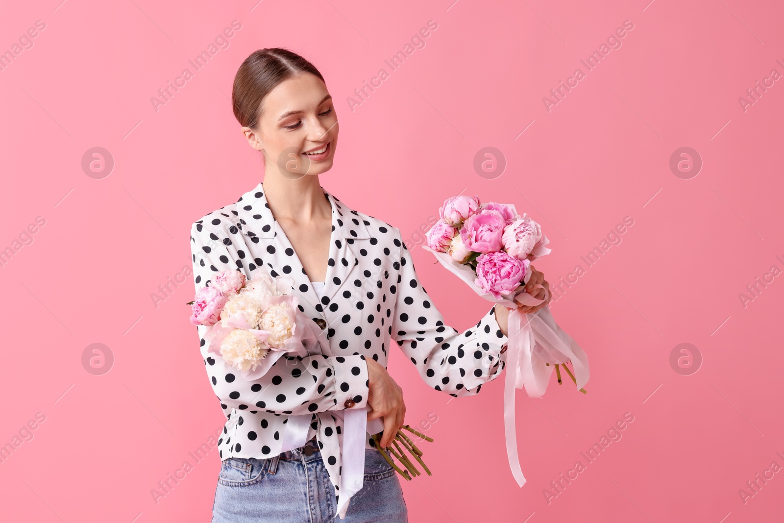 Woman with beautiful bouquets of peonies on pink background Photo of Woman with beautiful bouquets of peonies on pink background