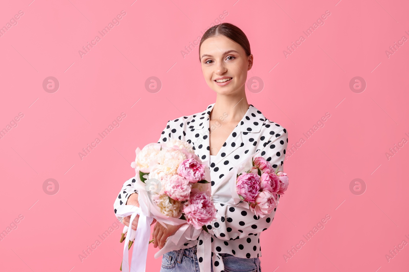 Woman with beautiful bouquets of peonies on pink background Photo of Woman with beautiful bouquets of peonies on pink background