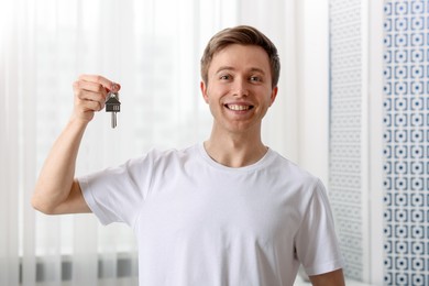 Photo of Happy man with house keys at home