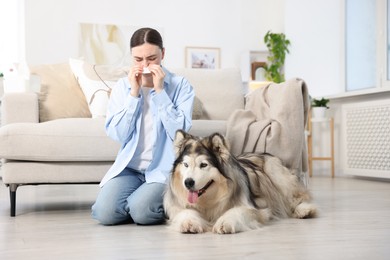 Photo of Woman suffering from allergy with her dog at home