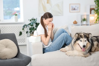 Photo of Woman suffering from allergy with her dog at home