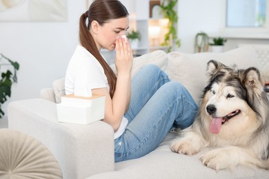 Photo of Woman suffering from allergy with her dog at home