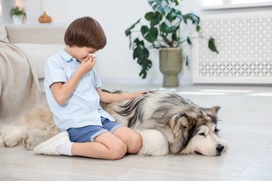 Photo of Boy suffering from allergy with her dog at home