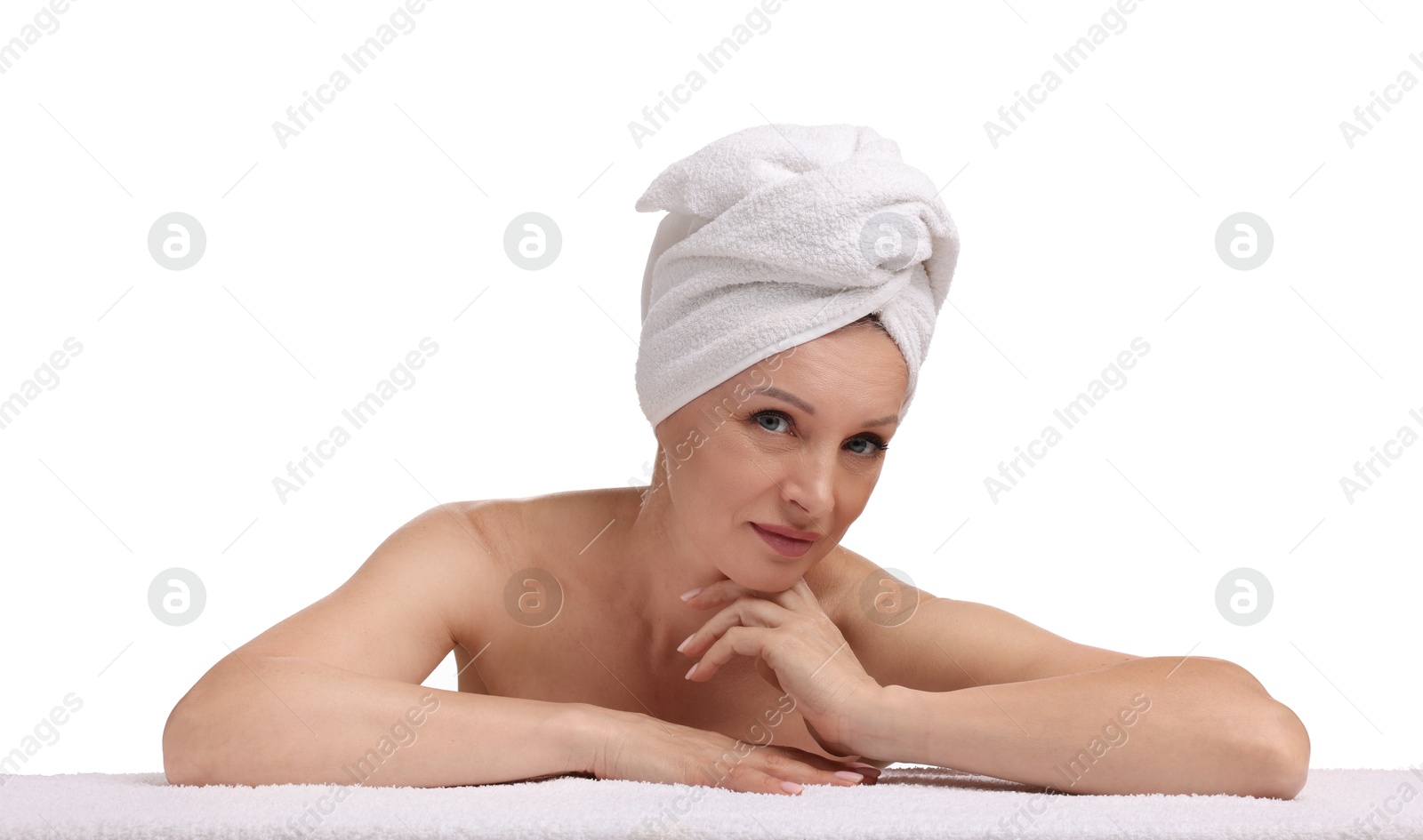 Beautiful woman with towel wrapped on her head against white background Photo of Beautiful woman with towel wrapped on her head against white background