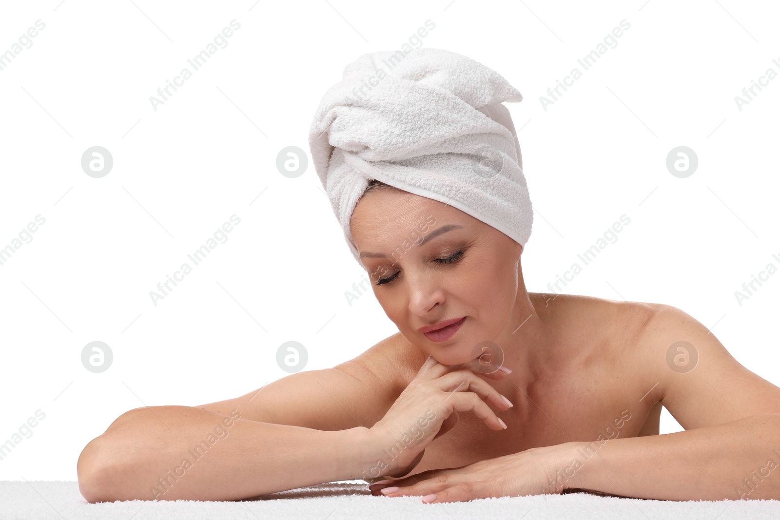 Beautiful woman with towel wrapped on her head against white background Photo of Beautiful woman with towel wrapped on her head against white background