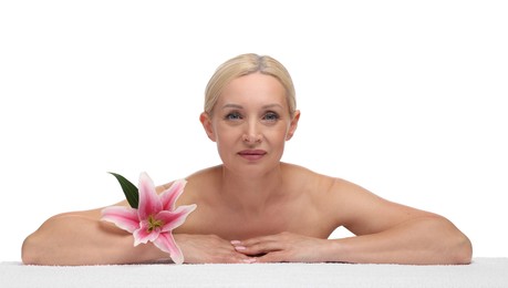 Photo of Beautiful woman with lily flower and towel on white background
