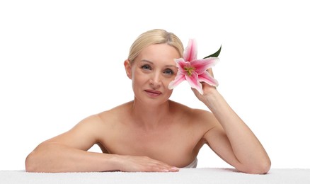 Photo of Beautiful woman with lily flower and towel on white background