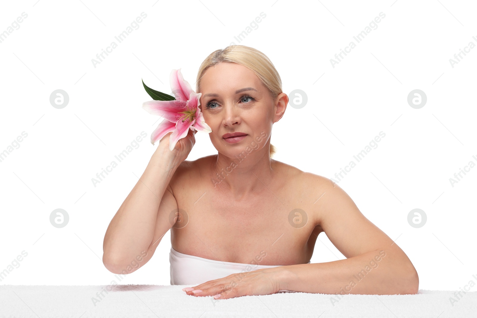 Beautiful woman with lily flower and towel on white background Photo of Beautiful woman with lily flower and towel on white background