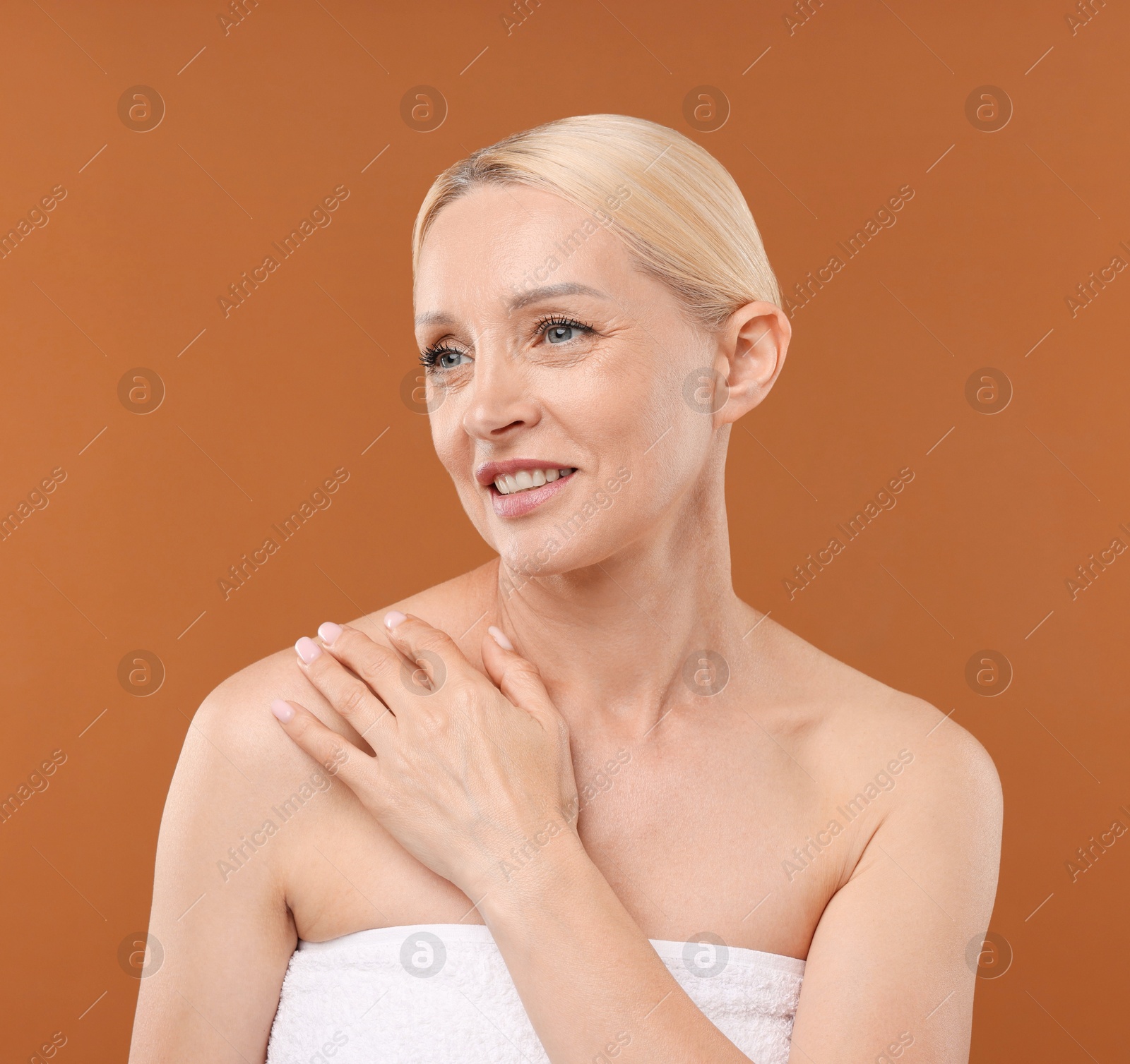 Portrait of beautiful woman on brown background Photo of Portrait of beautiful woman on brown background