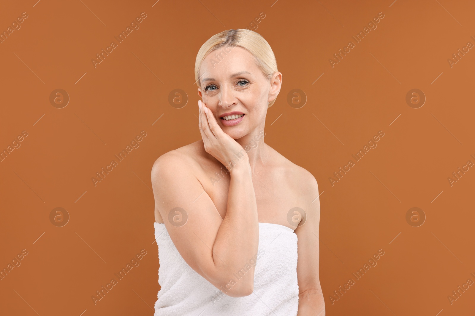 Portrait of beautiful woman on brown background Photo of Portrait of beautiful woman on brown background
