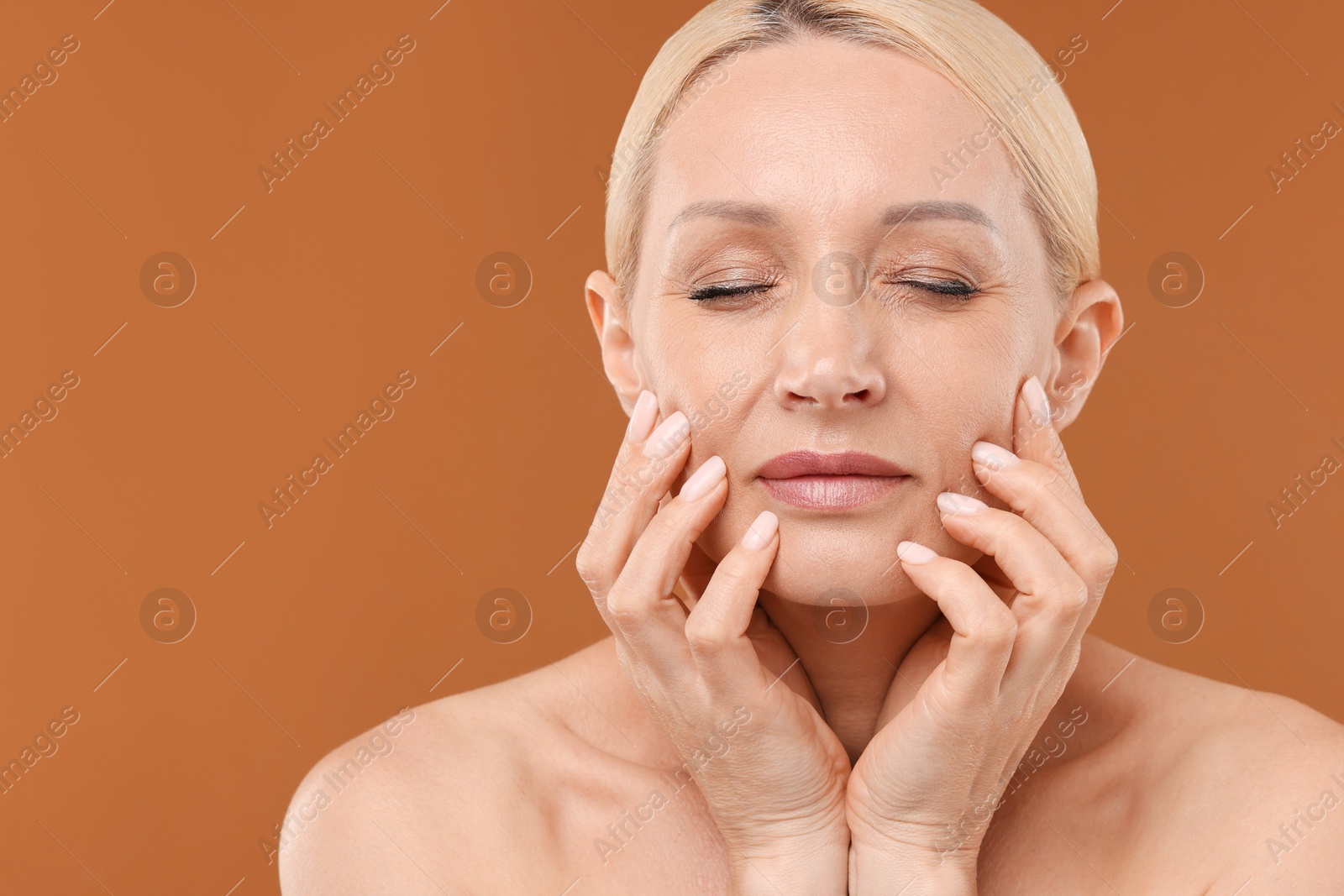 Portrait of beautiful woman on brown background, closeup. Space for text Photo of Portrait of beautiful woman on brown background, closeup. Space for text