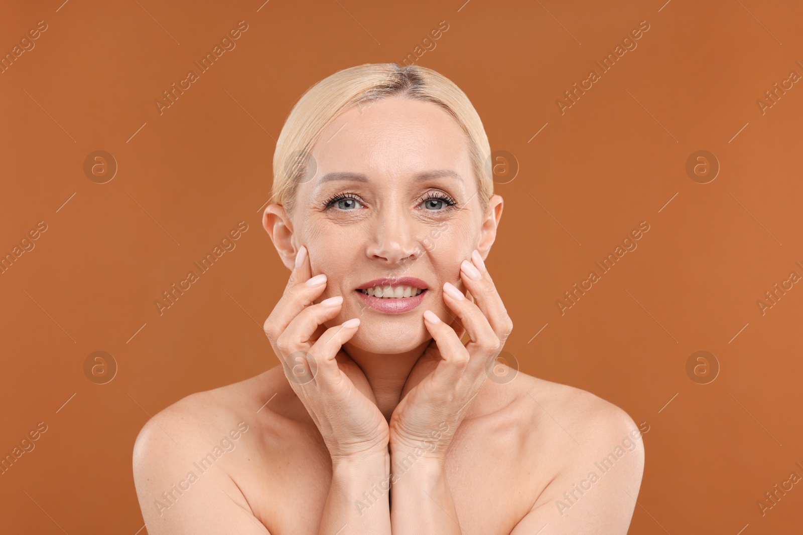 Portrait of beautiful woman on brown background Photo of Portrait of beautiful woman on brown background