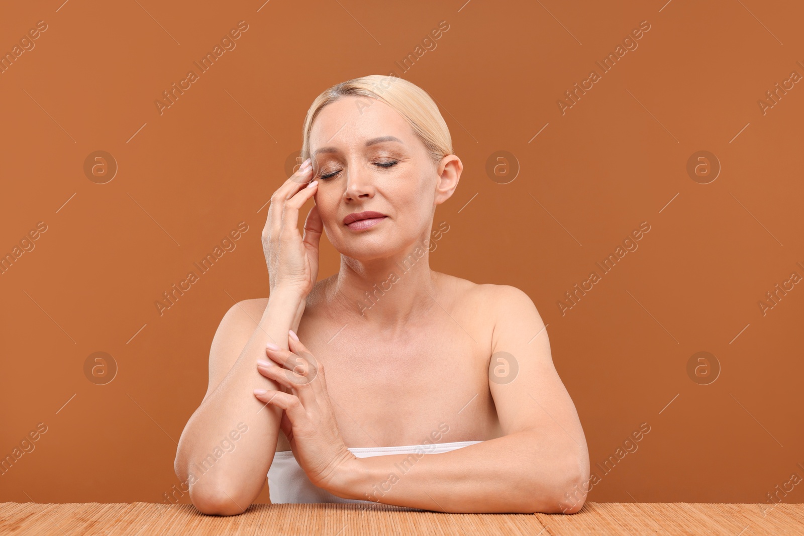 Portrait of beautiful woman on brown background Photo of Portrait of beautiful woman on brown background