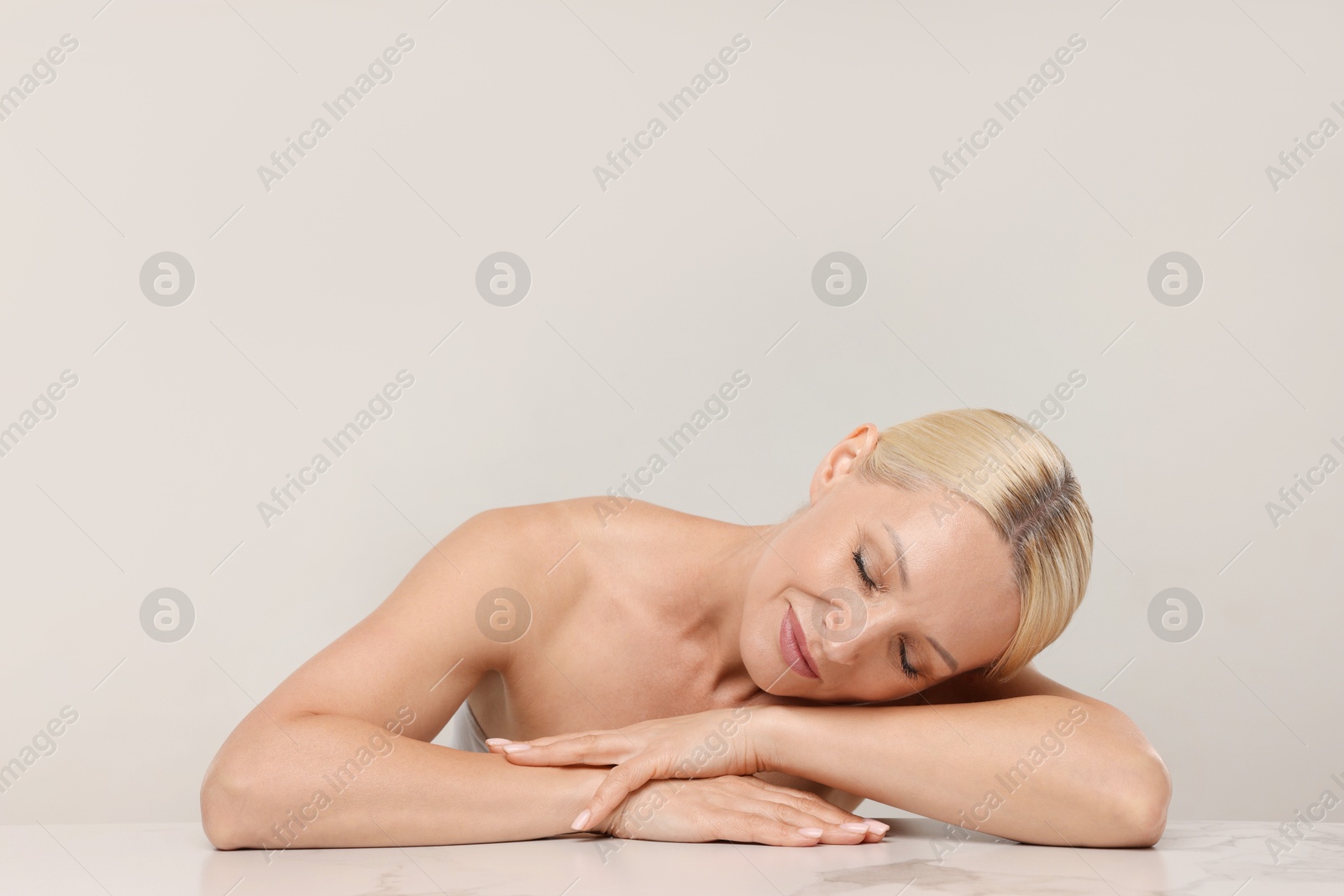 Portrait of beautiful woman on light background. Space for text Photo of Portrait of beautiful woman on light background. Space for text