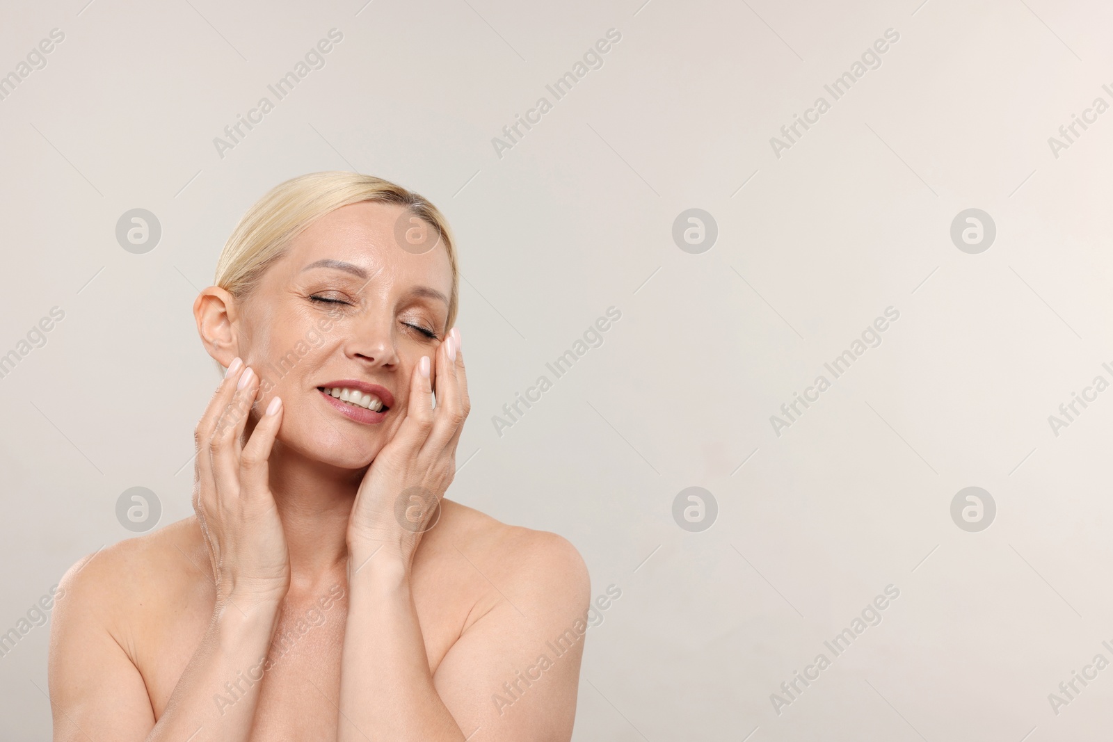 Portrait of beautiful woman on light background. Space for text Photo of Portrait of beautiful woman on light background. Space for text