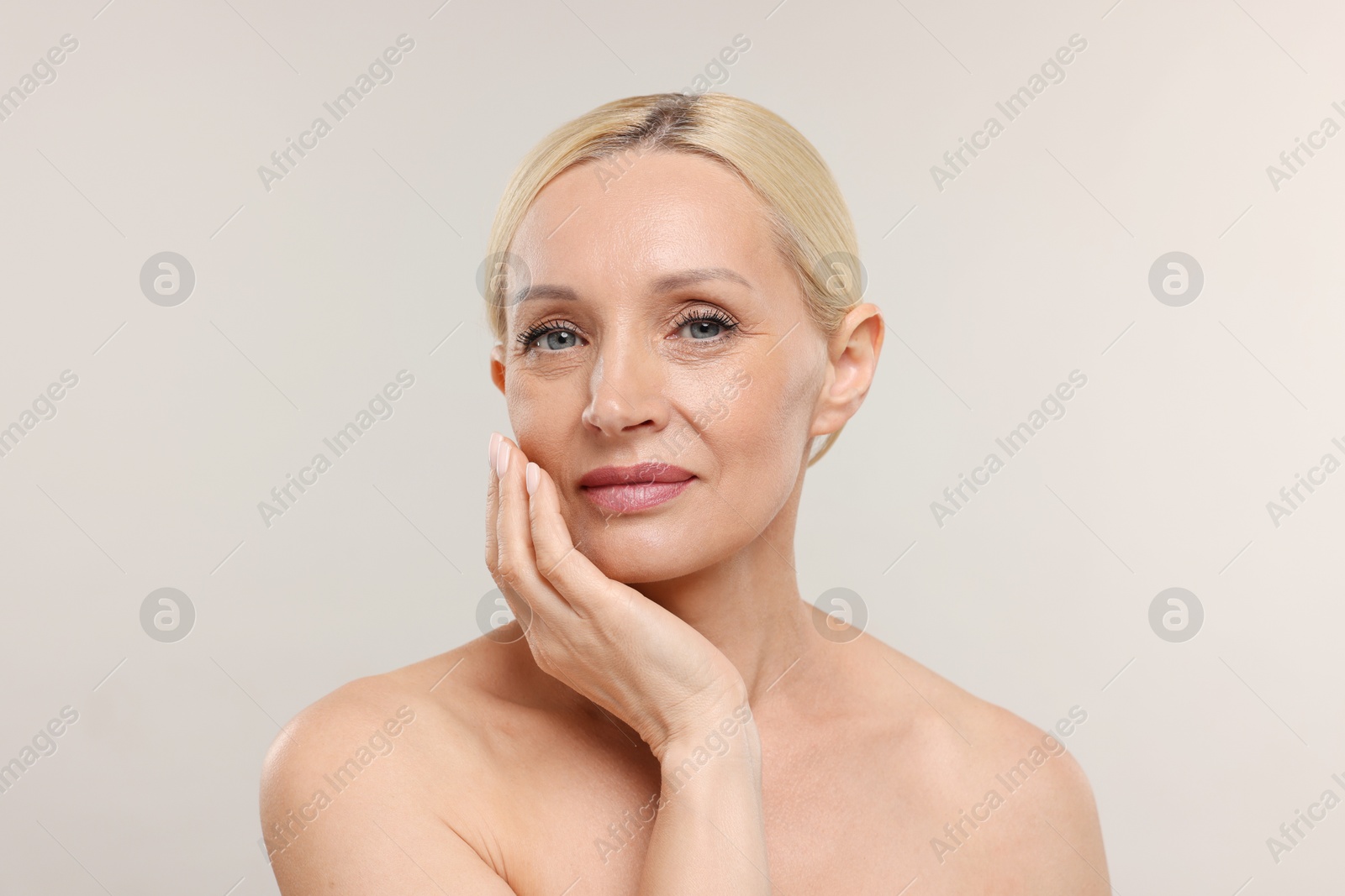 Portrait of beautiful woman on light background Photo of Portrait of beautiful woman on light background