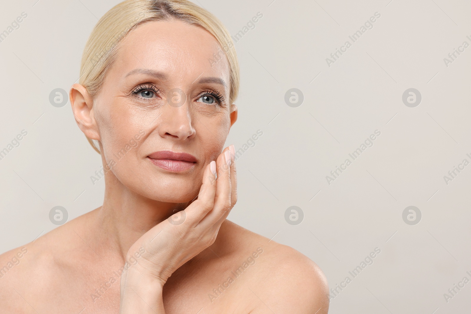 Portrait of beautiful woman on light background. Space for text Photo of Portrait of beautiful woman on light background. Space for text