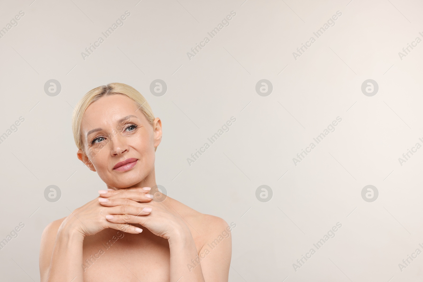 Portrait of beautiful woman on light background. Space for text Photo of Portrait of beautiful woman on light background. Space for text
