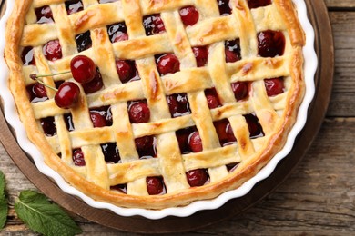 Photo of Tasty cherry pie on wooden table, top view
