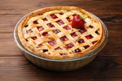 Photo of Tasty strawberry pie on wooden table, closeup