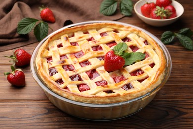 Photo of Tasty strawberry pie on wooden table, closeup