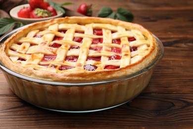 Photo of Tasty strawberry pie on wooden table, closeup